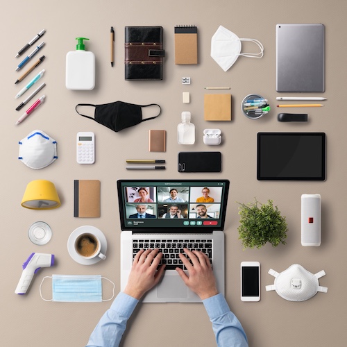 Flat lay top view desk working space with laptop, video call, home office, business and coronavirus concept.